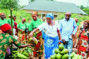 Mrs Elsie Udofia inspecting farm produce from the AHWEE Widows' farm during the 2024 International Women's Day Celebration held by the foundation   in Obotim Ikot Ekong,  Nsit Ibom local government area recently.